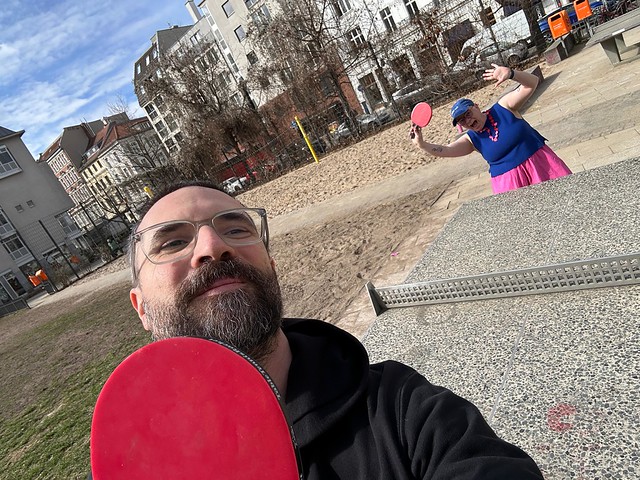 Nadja and a colleague playing table tennis outdoors